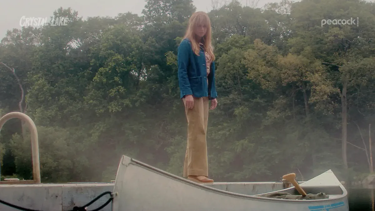 Linda Cardellini as Pam Voorhees standing in a canoe on the lake
